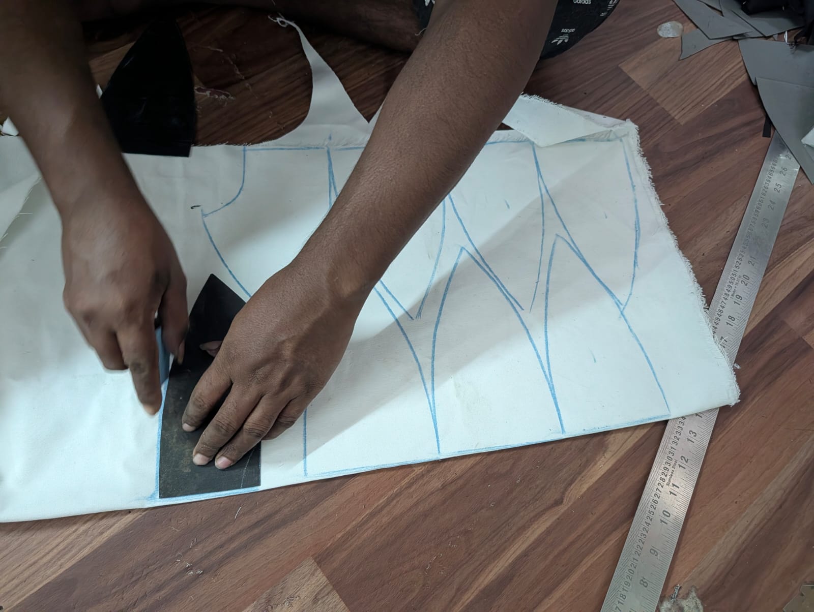 marking the cutting area of the fabric for a custom cap manufacturing in india